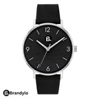 Minimalist wristwatch with a black dial, silver case, and black leather strap.