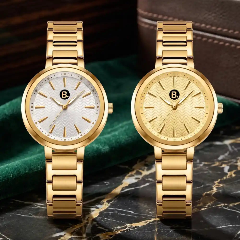 Two elegant gold luxury watches with textured dials on a dark marble surface.