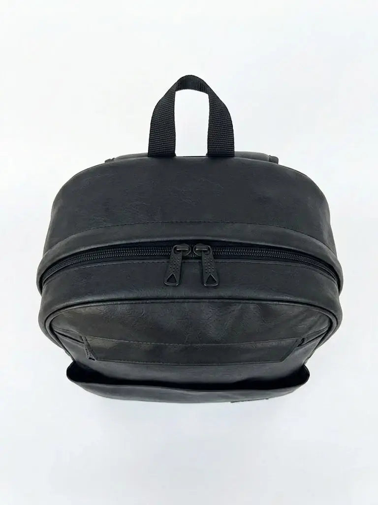 Black faux leather mini backpack with dual zipper compartments and top carry handle.