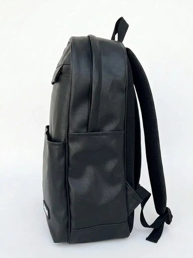 Side view of a sleek black faux leather backpack with adjustable shoulder straps.